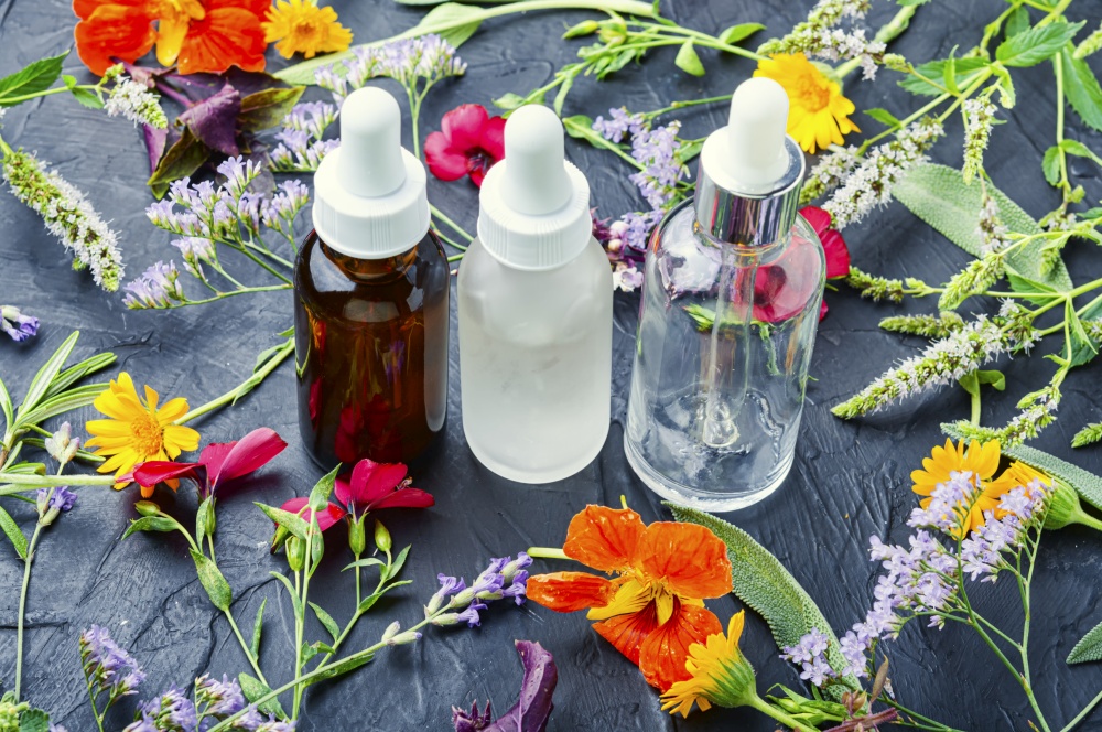 Medical essential oils of flowers and herbs.Herbal essence.Natural herbal medicine. Bottle with herb essential oil