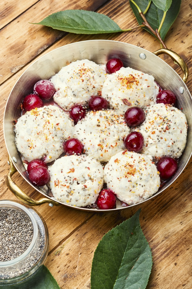 Czech dumplings or knedliky with cherry filling on wooden table. Delicious sweet cherry dumplings