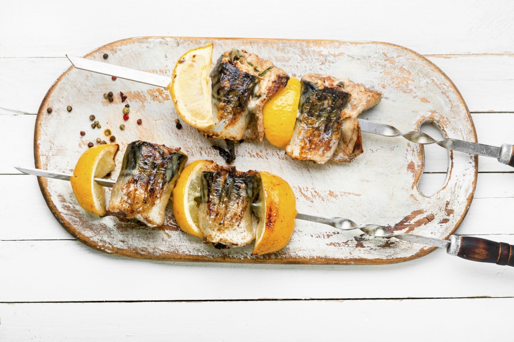 Grilled skewers of mackerel with lemon.Grilled fish kebab. Grilled fish on skewers.