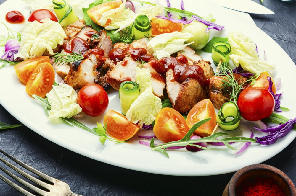 Appetizing salad with tomato,cucumber,lettuce and meat steak.Sliced grilled steak. Meat salad with fresh vegetables.