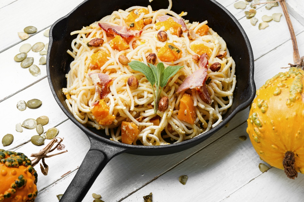 Pasta or spaghetti with pumpkin and bacon.Pasta carbonara.Seasonal autumn food. Autumn pasta with pumpkin and bacon