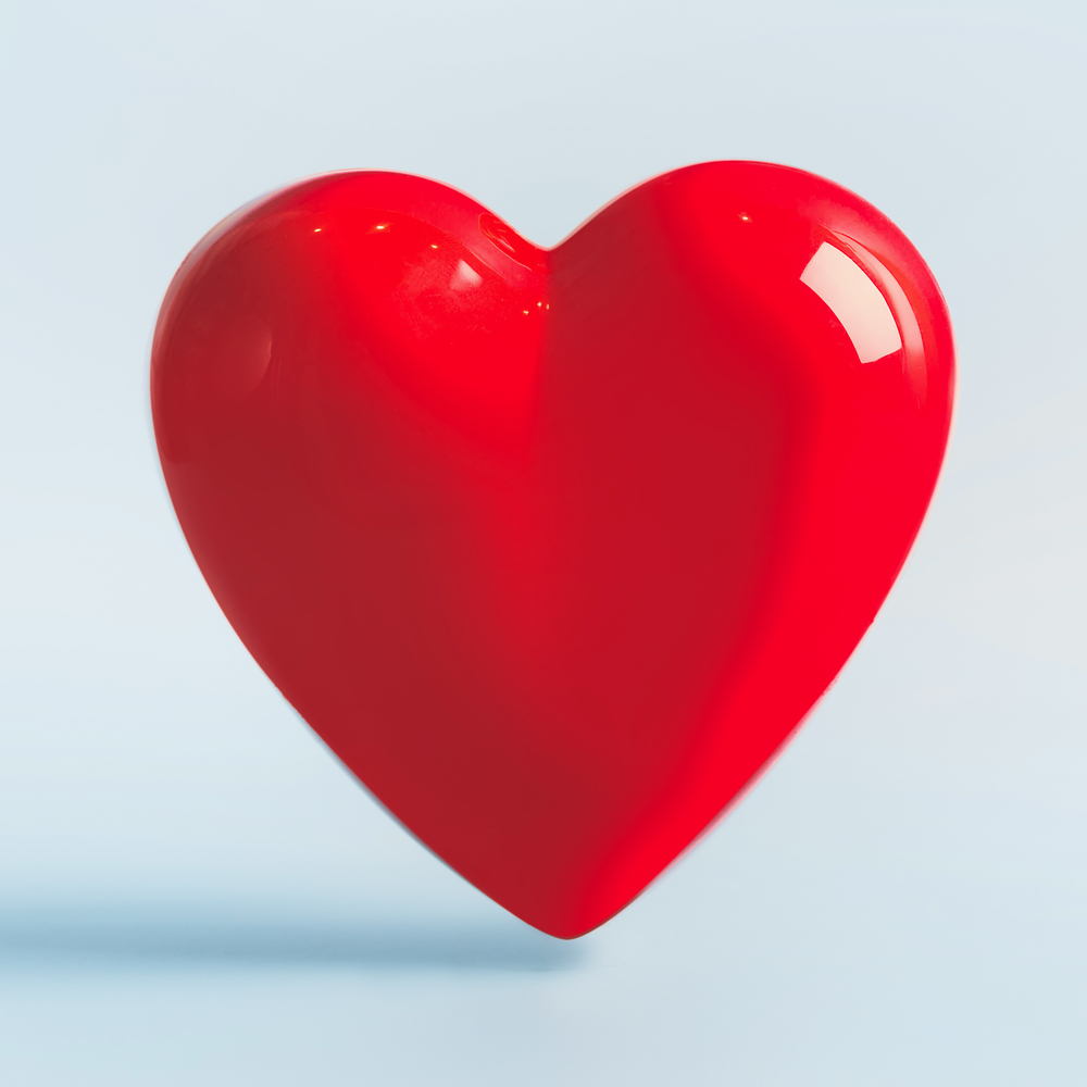 Red heart on light blue background. Love symbol