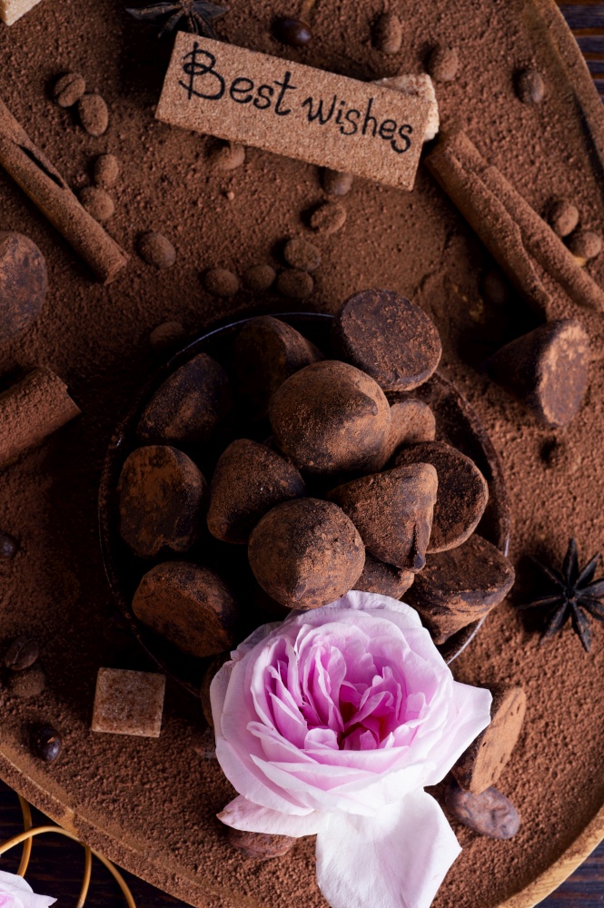 healthy delicious chocolate truffles around ingridients with natural cocoa  powder, cacao butter, cane sugar and rose. healthy sweets concept. flat lay