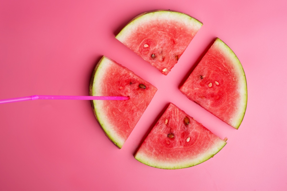 conceptual shot with slices of ripe watermelon at pink background