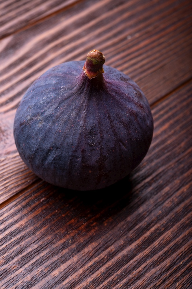 tasty ripe fig fruit  on wooden table. close up
