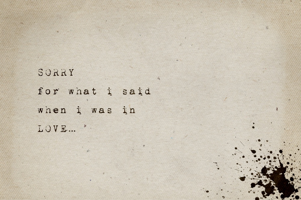 Sorry for what i said when i was in love. Minimalist text art, conceptual illustration, typewriter font style written on old paper texture. Life drama, breakup greeting card, lettering composition.