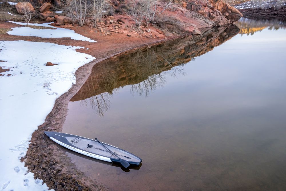 stand up paddleaboard on a calm lake at Colorado foothills (Horsetooth Reservoir), aerial view of winter scenery