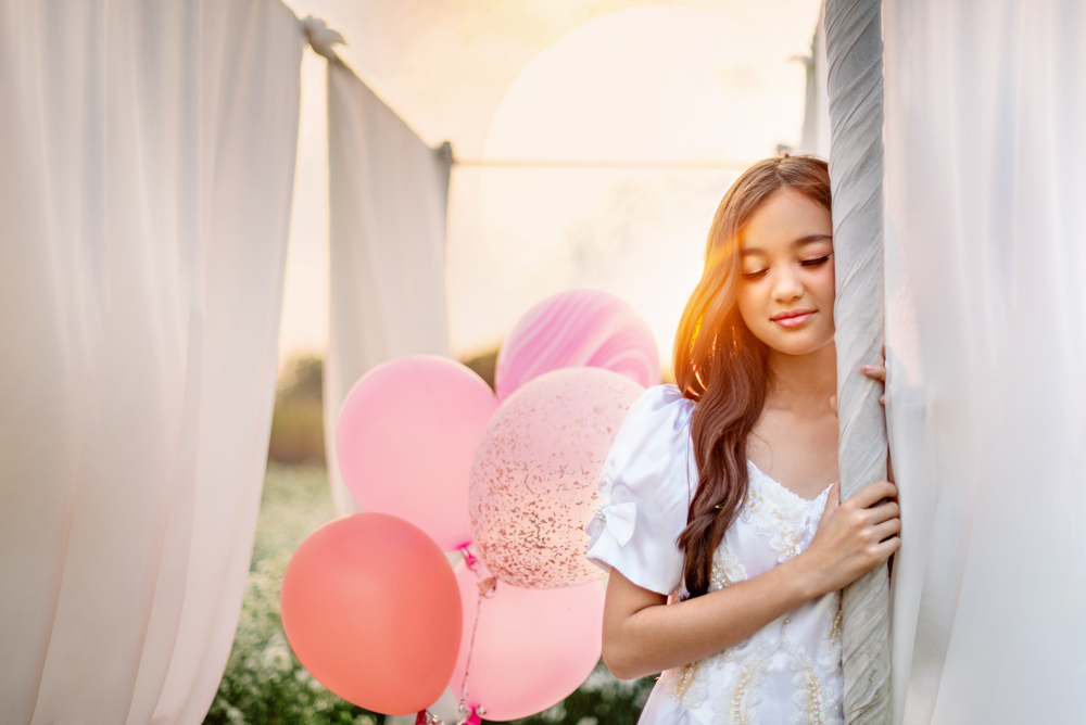 portrait of beautiful girl with balloon in nature field. beautiful girl with balloon in nature field