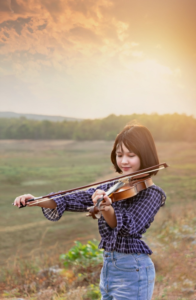 asian cute little girl with violin in field. asian cute little girl with violin
