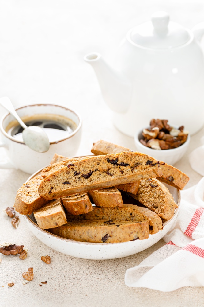Biscotti cookies with dried cranberry, walnuts and with a cup of coffee