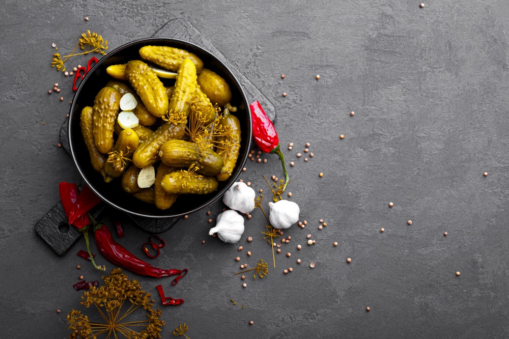 Homemade small preserved cucumbers, fermented, salted or marinated pickles with garlic, chili and dill