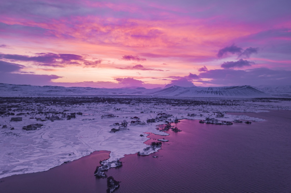 aerial shot of sunrise over Myvatn lake with Hverfjall volcano in the back, Iceland