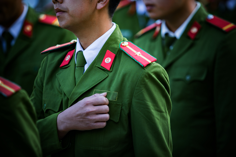 soldier with green uniform marching in row