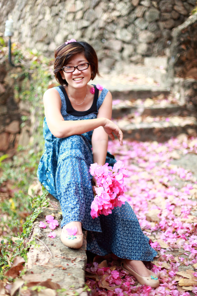 asian woman with pink flower bouquet in her hand smilling to camera. asian woman with pink flower bouquet in her hand smilling to camera with nice emotion