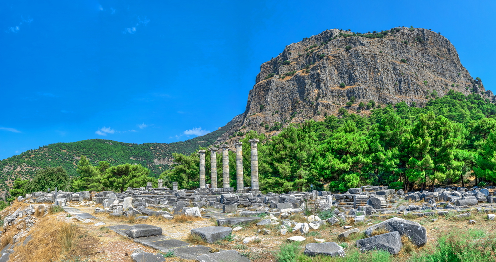 Ruins of the Temple of Athena Polias in the ancient city of Priene, Turkey, on a sunny summer day. Big panoramic shot.. The Temple of Athena Polias in the Ancient Priene, Turkey