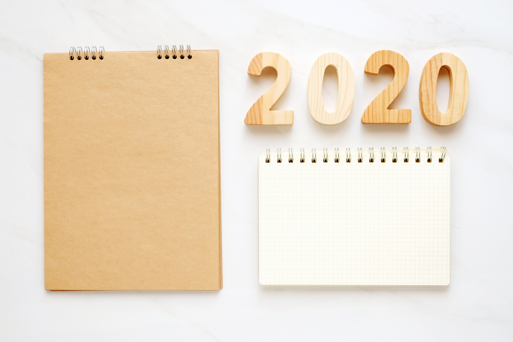 2020 on wood box, blank notebook paper on white marble table background, 2020 new year mock up, template with copy space for text, top view