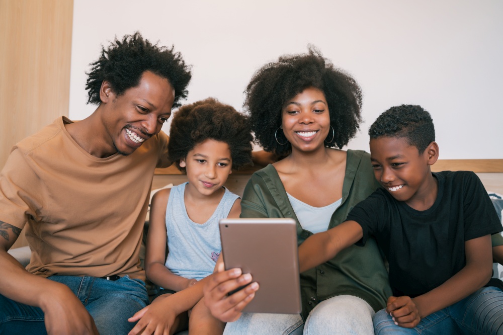 Portrait of african american family taking a selfie together with digital tablet at home. Family and lifestyle concept.