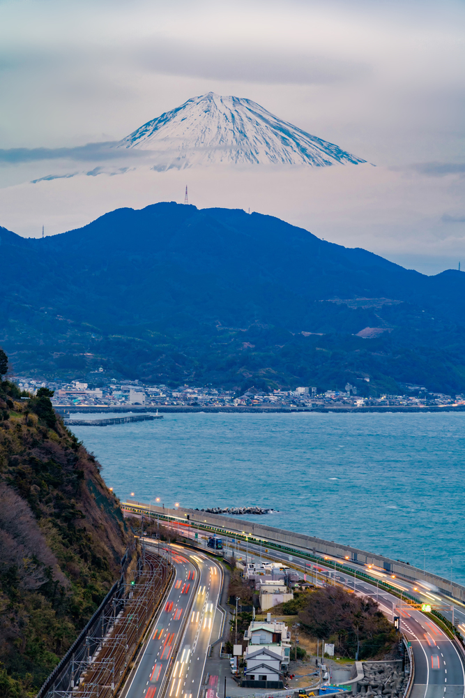 Satta Pass. Aerial view of Mountain Fuji with highway and express way, roads or streets at night in Shizuoka. Fuji five lakes, Japan. Nature landscape background with hills.