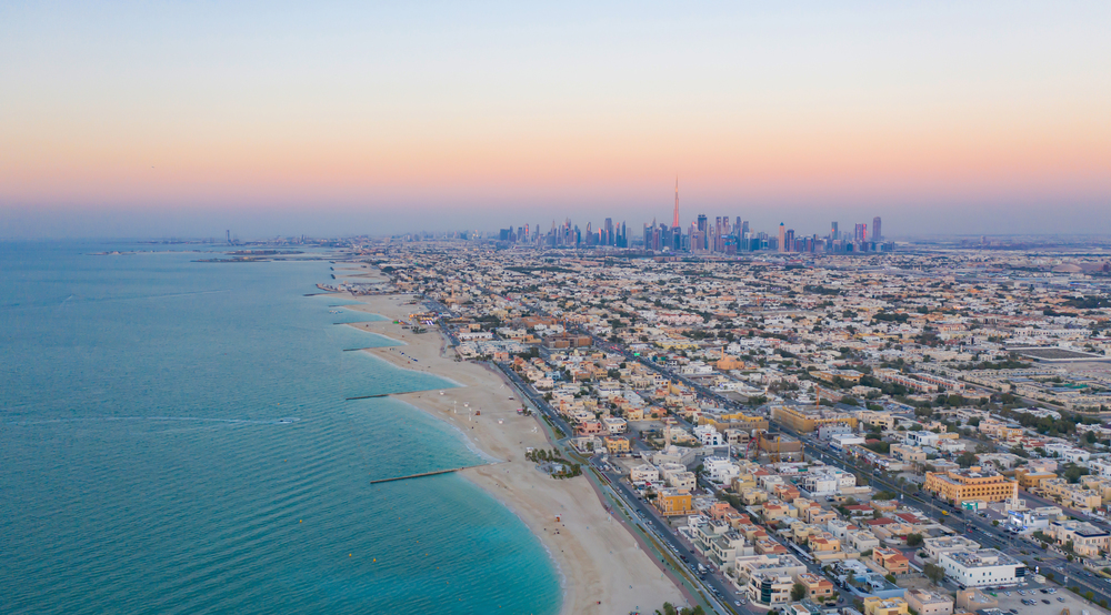 Aerial view of Dubai sea coast beach with downtown skyline, bay in United Arab Emirates or UAE. Financial district and business area in smart urban city. Skyscraper and high-rise buildings.