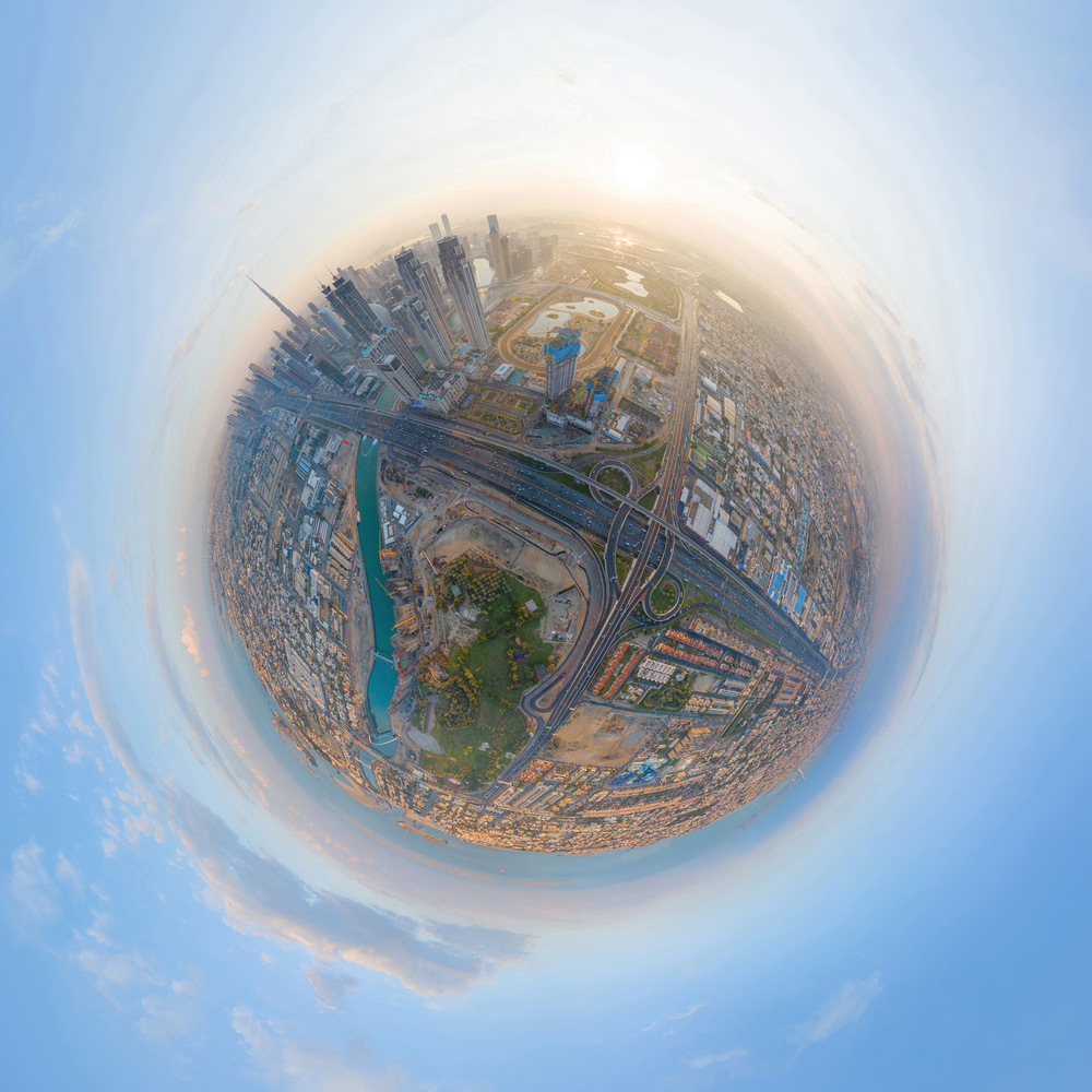 Little planet 360 degree sphere. Panorama of aerial view of Dubai Downtown skyline and highway, United Arab Emirates or UAE. Financial district in urban city. Skyscraper buildings at sunset.