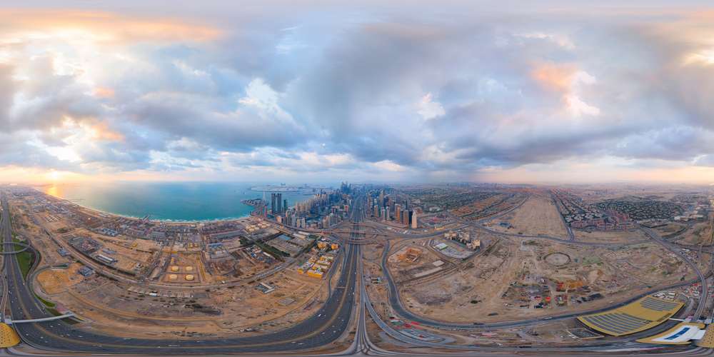 360 panorama by 180 degrees angle seamless panorama of aerial view of Dubai Downtown skyline and highway, United Arab Emirates or UAE. Financial district in urban city. Skyscraper buildings at sunset.