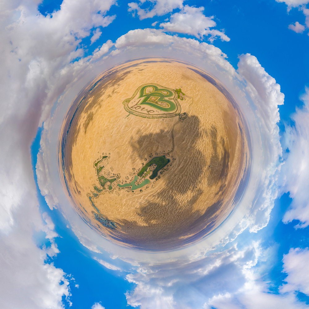 Little planet 360 degree sphere. Panorama of aerial top view of love lake and sand desert, Heart shaped lakes in Al Qudra in Dubai, United Arab Emirates or UAE.  A new tourist destination.