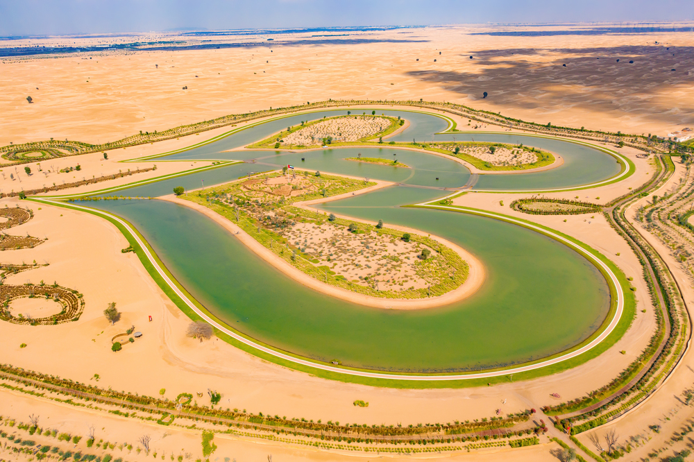 Aerial top view of love lake and sand desert, Heart shaped lakes in Al Qudra in Dubai, United Arab Emirates or UAE.  A new tourist destination for valentine day. Natural landscape background