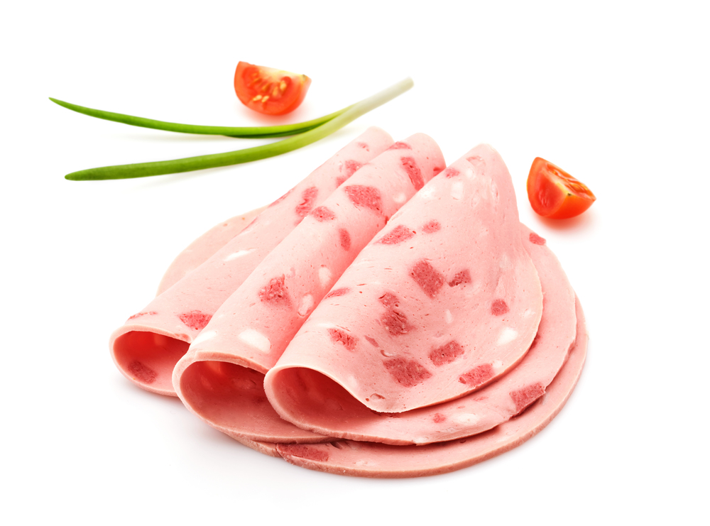 Sausage slices with herbs and tomatoes isolated on white background