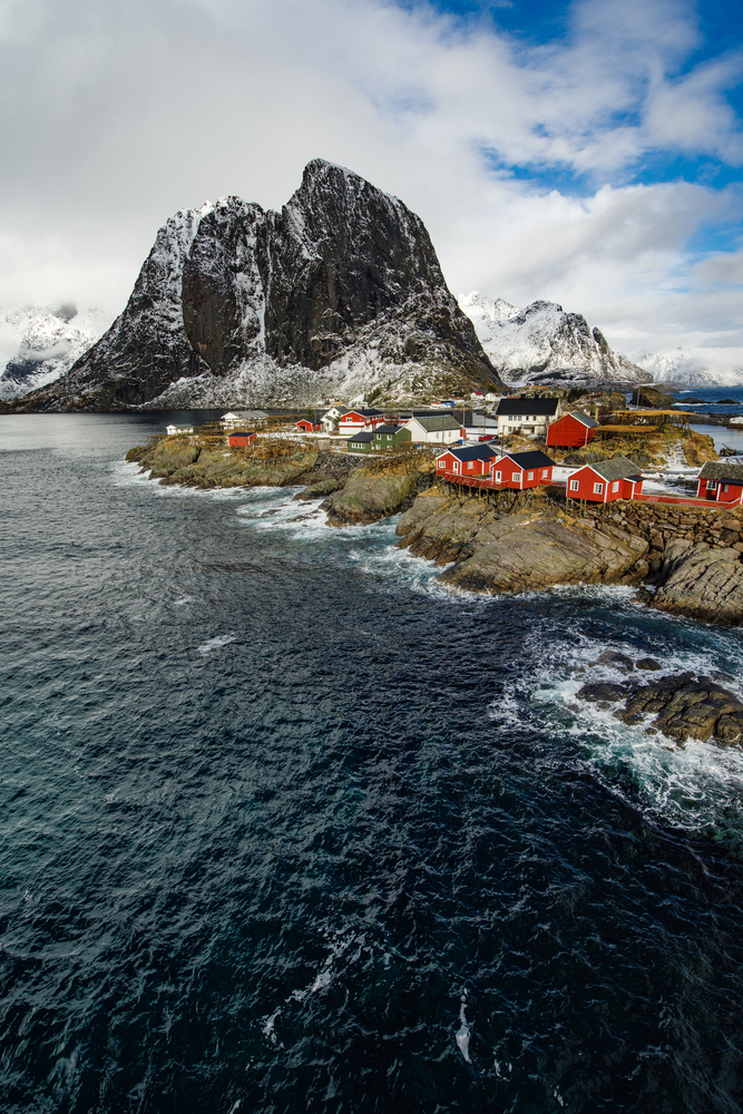 Famous tourist attraction Hamnoy fishing village on Lofoten Islands, Norway with red rorbu houses in winter