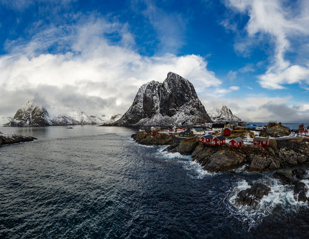 Panorama of famous tourist attraction Hamnoy fishing village on Lofoten Islands, Norway with red rorbu houses in winter