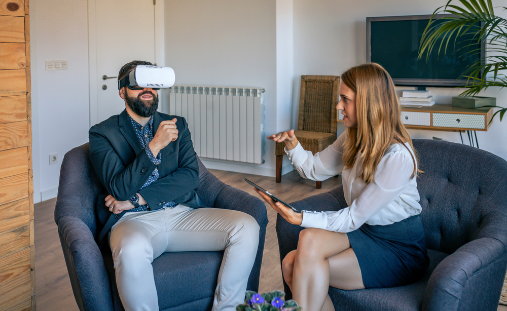 Businessman in an informal work meeting using virtual reality glasses. Businessman using virtual reality glasses