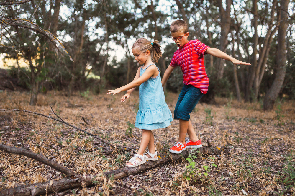Two kids playing in the forest
