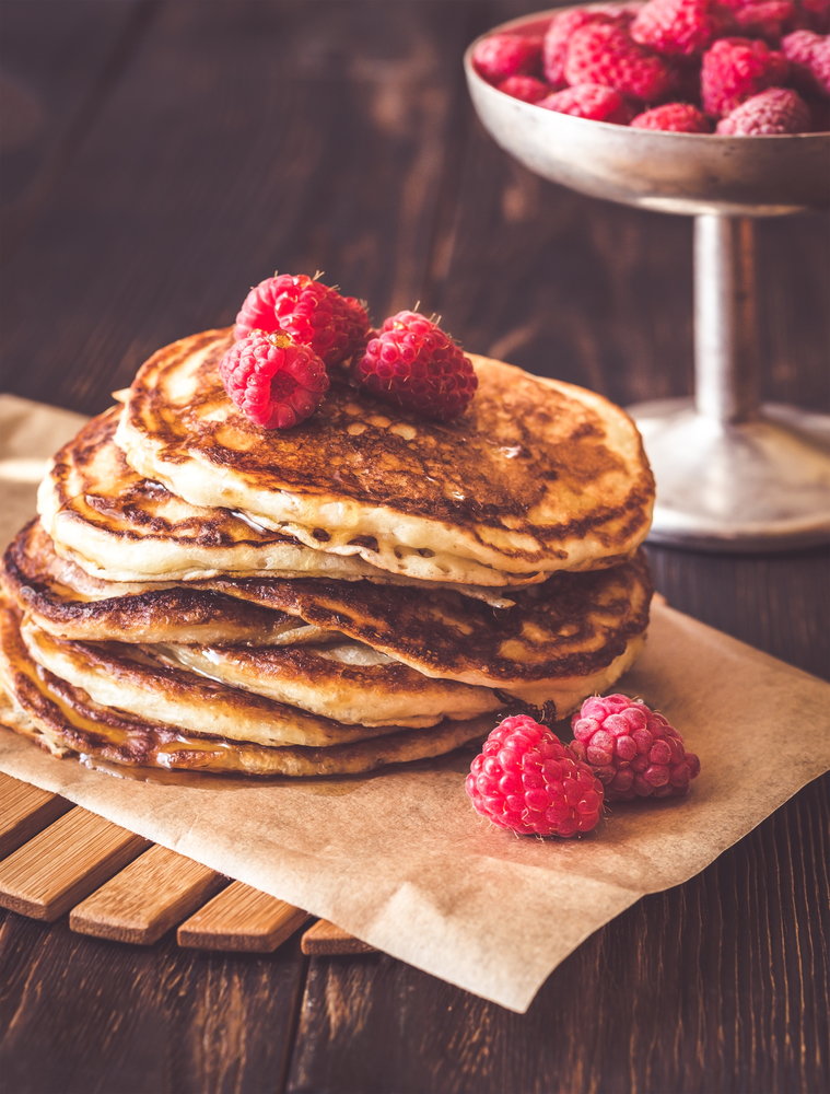 Stack of pancakes with fresh raspberries close-up