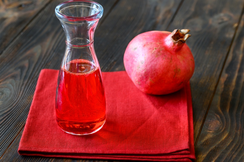 Glass jug of pomegranate grenadine syrup