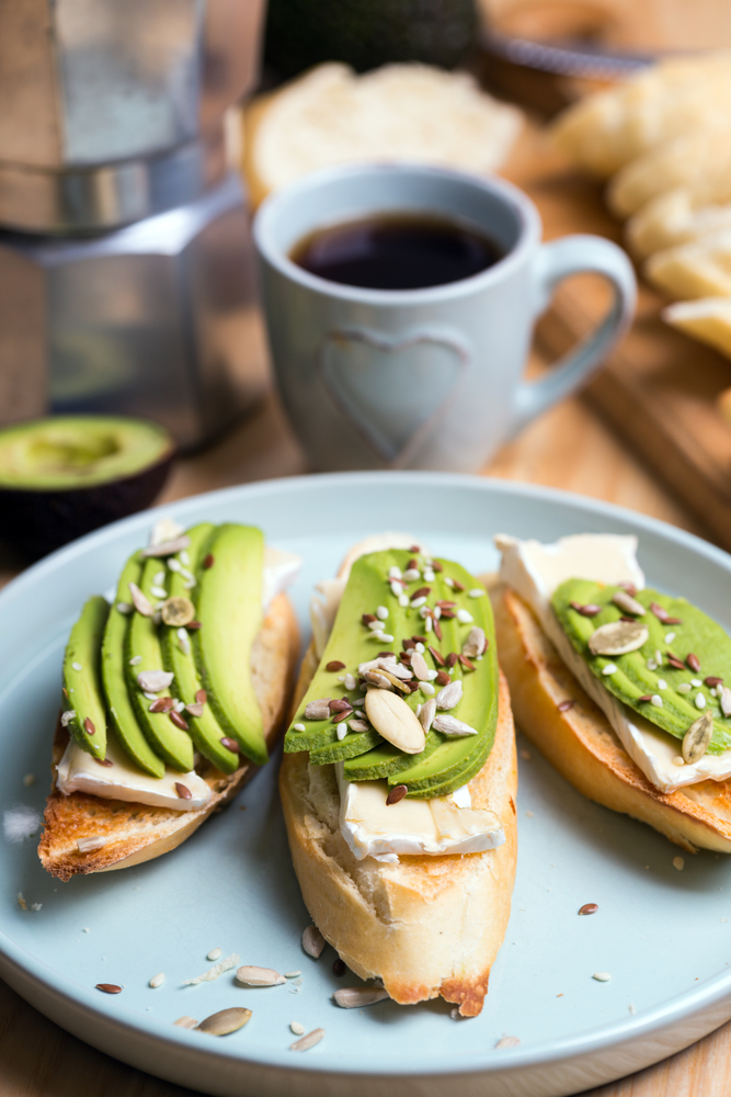 baguette with cheese brie and avocado with coffee and geyser
