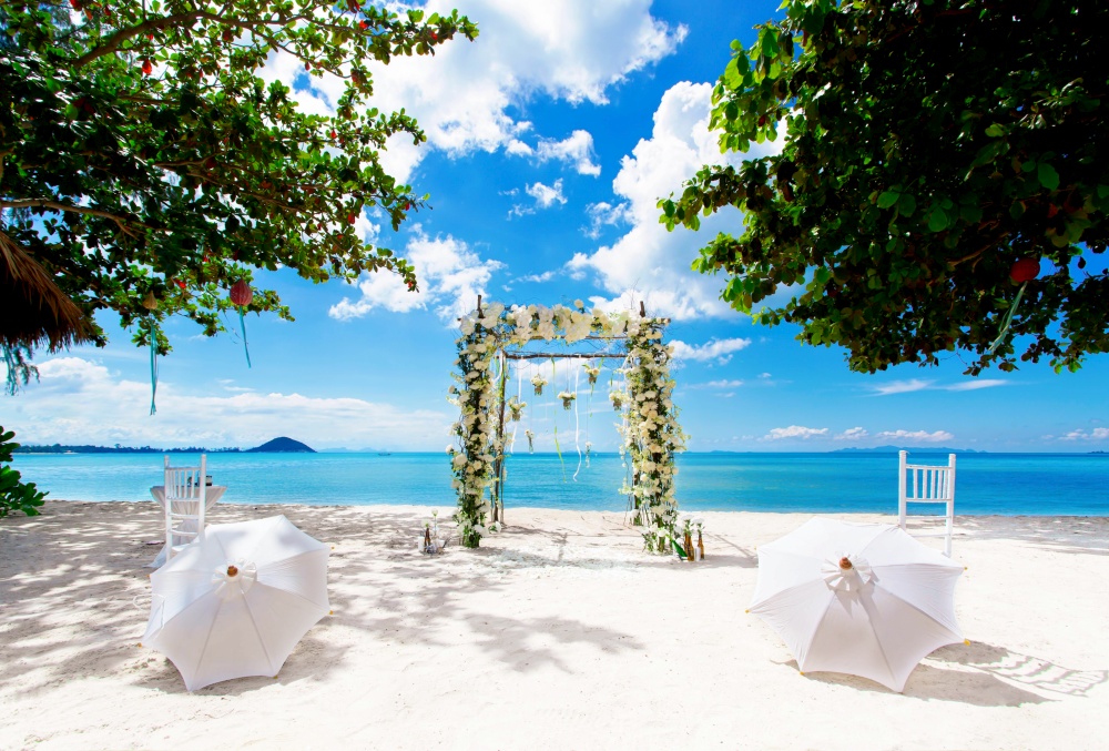 Wedding arch at the beach at bright sunny day