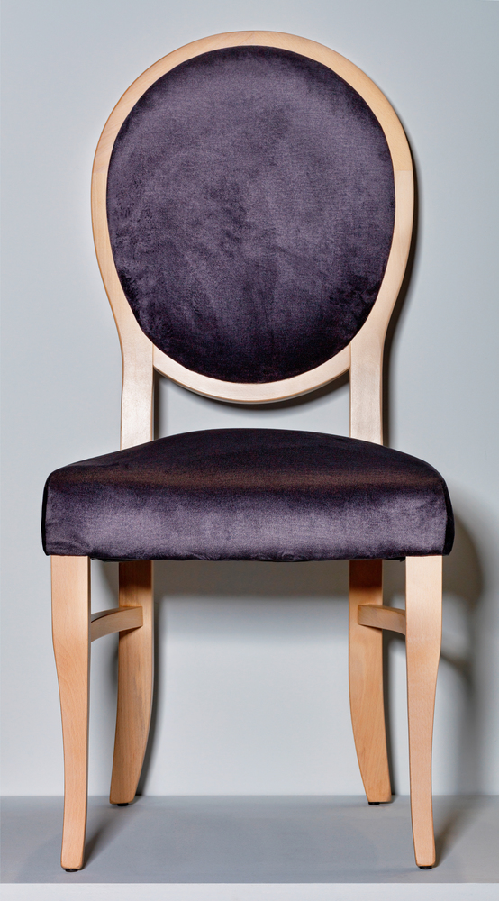 Classic wooden chair with soft dark purple upholstery and a round back, photographed in front, on a gray podium and background.. Wooden chair with a soft saddle and a round back on a gray podium and background.