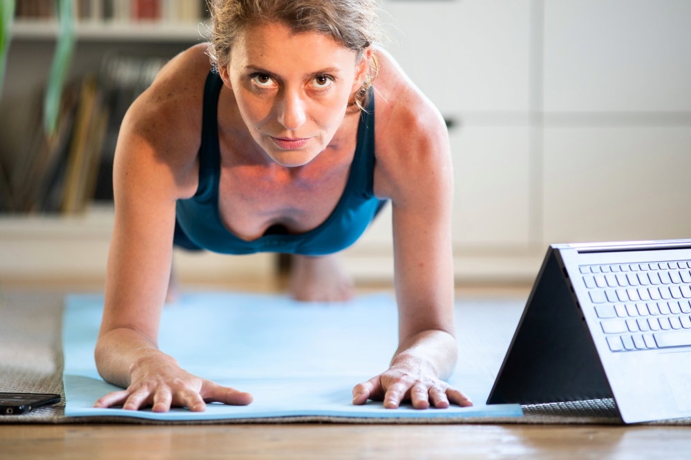 woman in plank position doing exercise at home