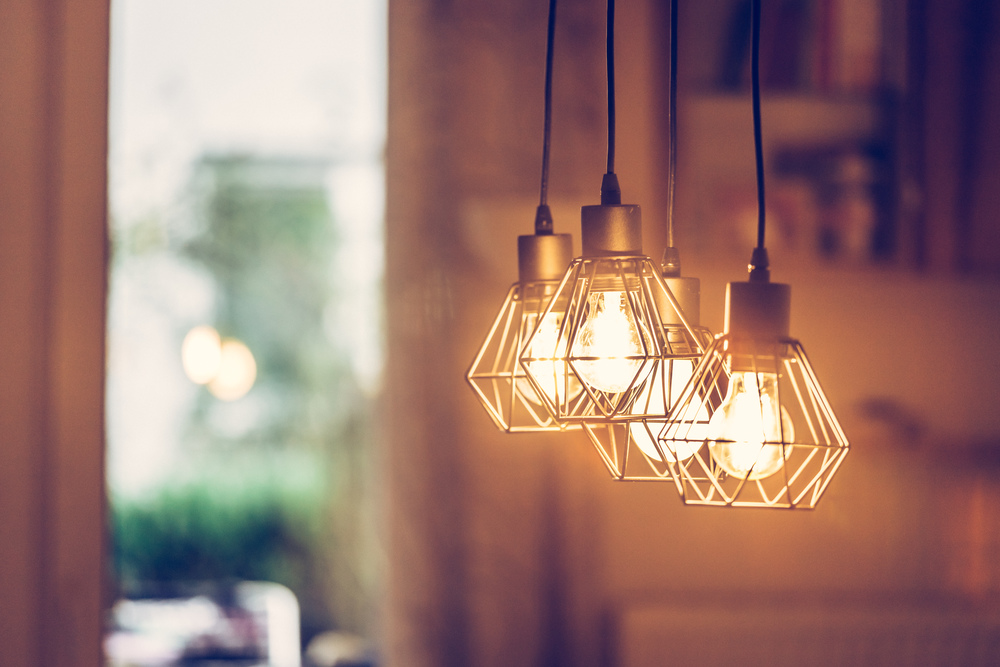 Close up picture of a hanging orange lightbulbs at home, in a restaurant or cafe