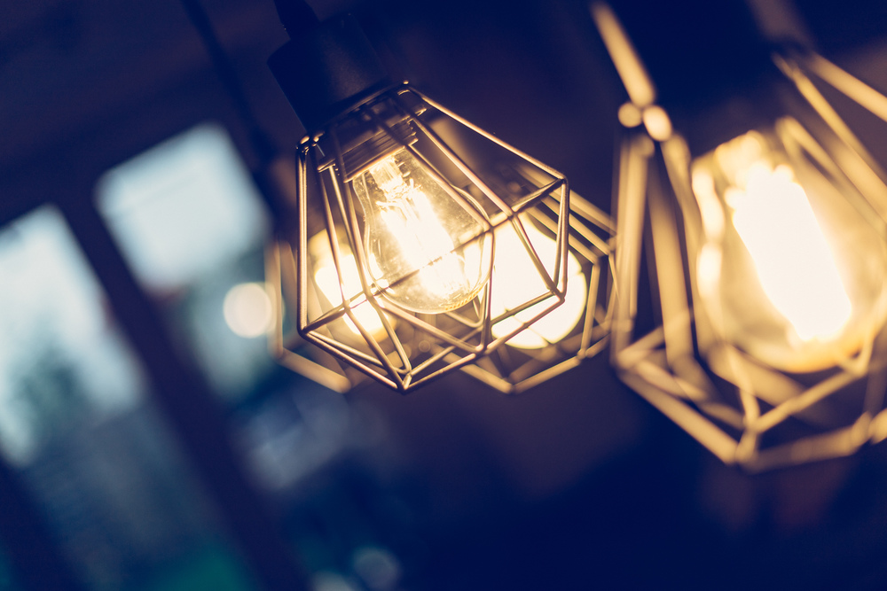 Close up picture of a hanging orange lightbulbs at home, in a restaurant or cafe