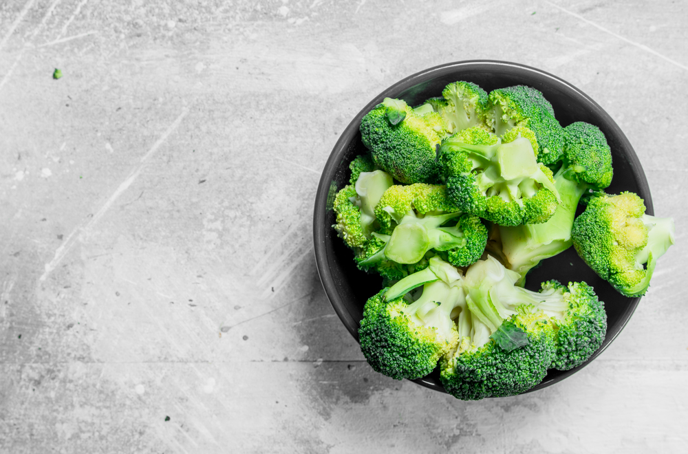 Broccoli in a bowl. On rustic background.. Broccoli in a bowl.
