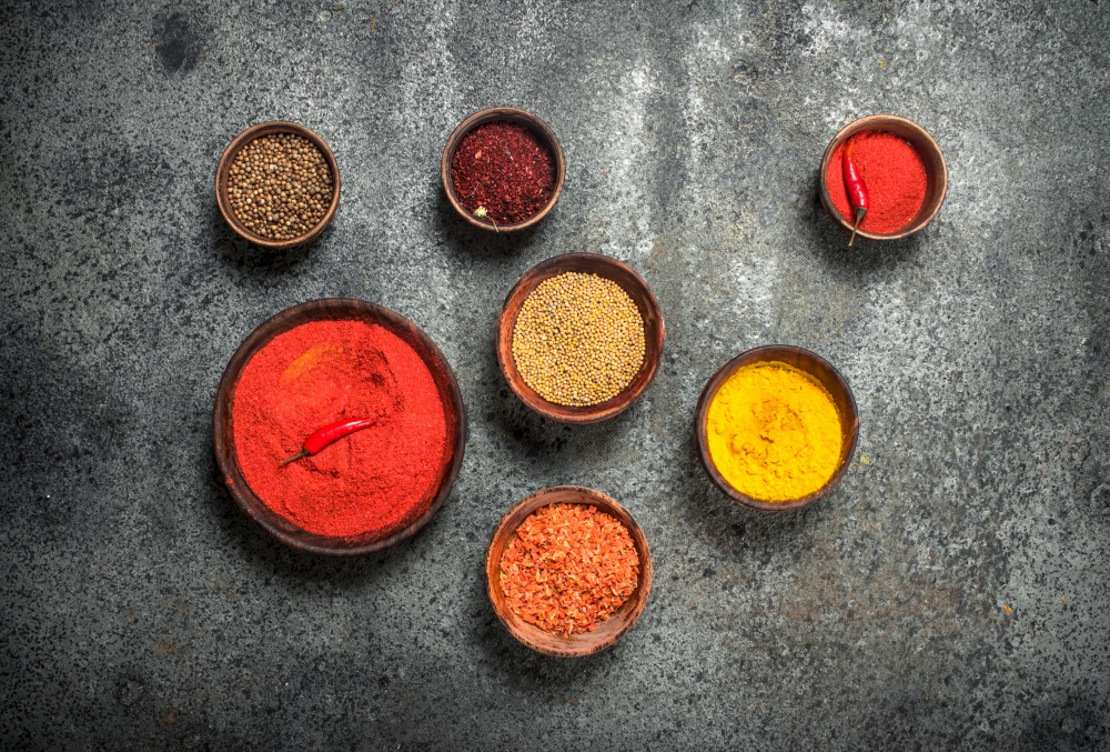 Ground spices in bowls. On a rustic background.. Ground spices in bowls.