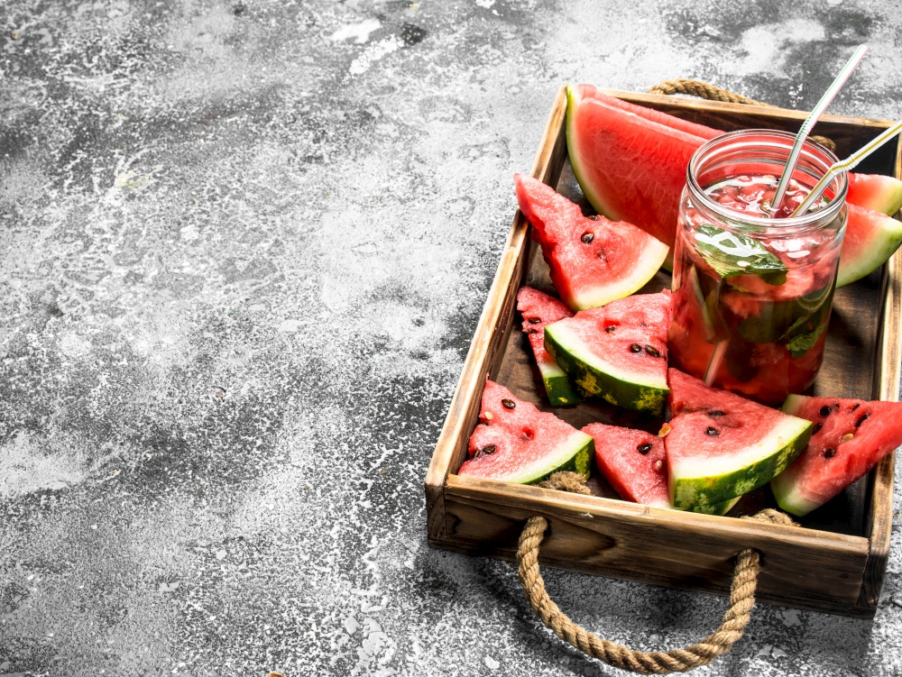 Watermelon cocktail on a wooden tray. On a rustic background.. Watermelon cocktail on a wooden tray.