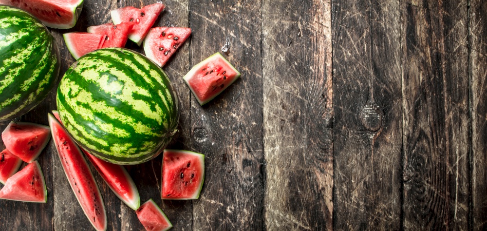 Fresh ripe watermelon. On a wooden background.. Fresh ripe watermelon.
