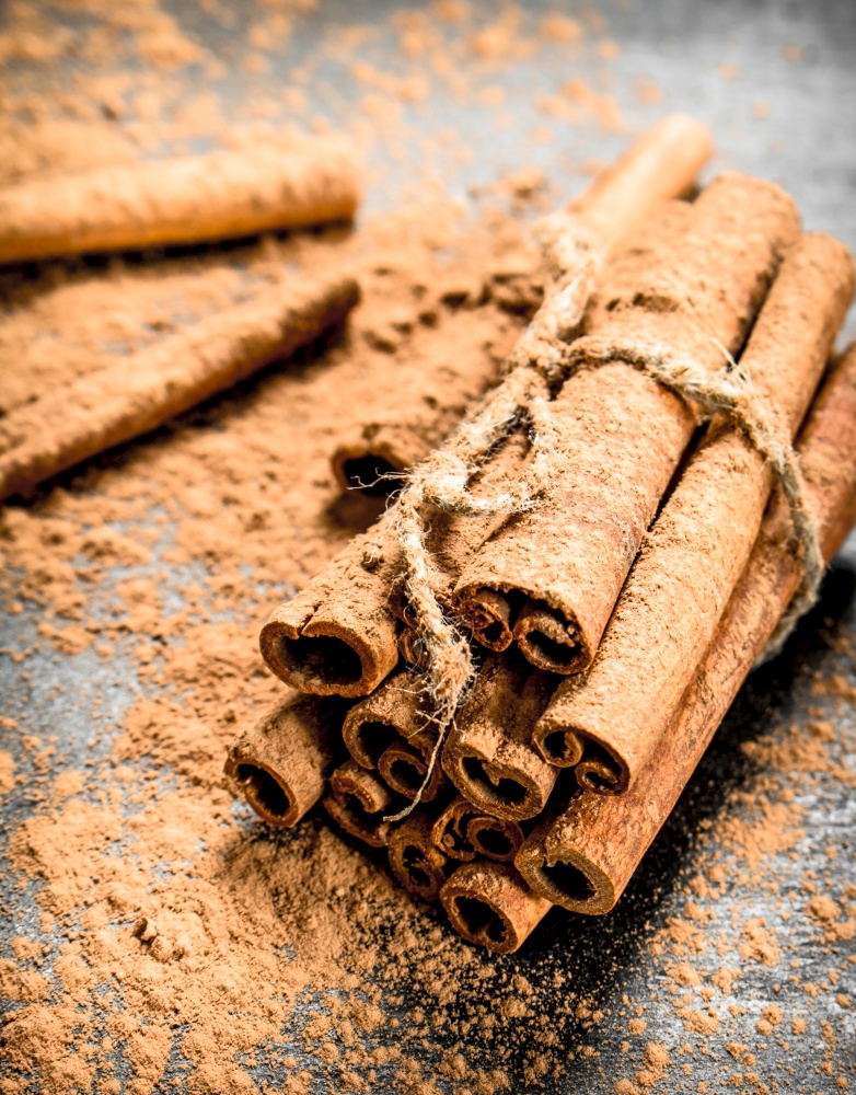 Cinnamon sticks. On a black wooden table.. Cinnamon spice sticks.