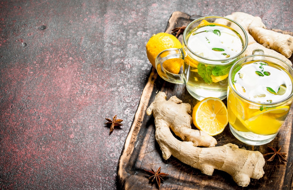 Ginger tea with mint and citrus. On rustic background.. Ginger tea with mint and citrus.