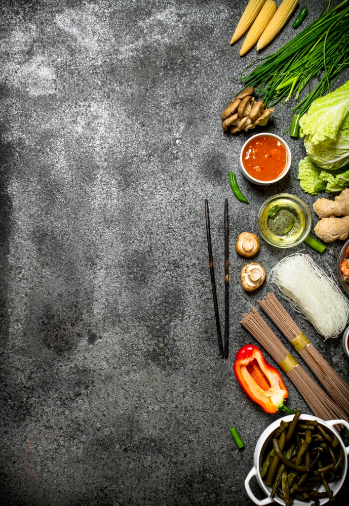 Asian food. A variety of ingredients for cooking Chinese or Thai food on a rustic background .