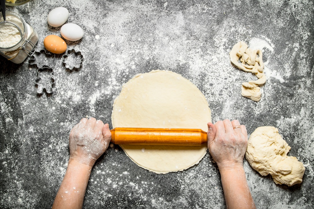 Dough background. The rolling of the hands of women for cookies. On rustic background.. Dough background. The rolling of the hands of women for cookies.