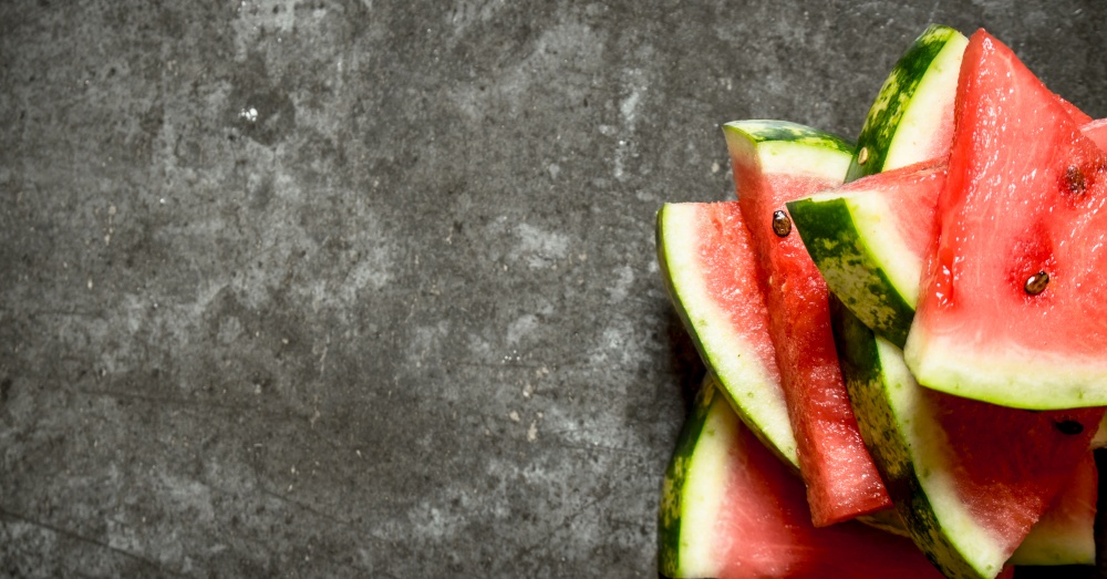 Slices of fresh watermelon. On the stone table. Slices of fresh watermelon.