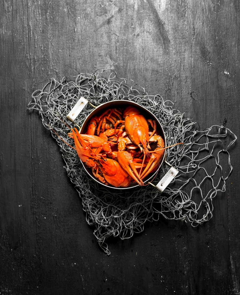 The food delicacies. Fresh boiled crawfish in the pot . On a black chalkboard.. The food delicacies. Fresh boiled crawfish in the pot .